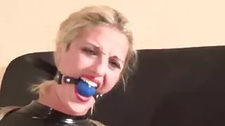 Helpless Gagged Blonde in catsuit tightly tied struggles