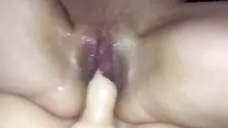 Riding her sex doll while playing with her pussy