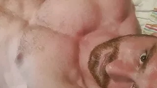 Muscular guy is masturbate in home