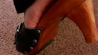 Mature feet tickle wooden clogs