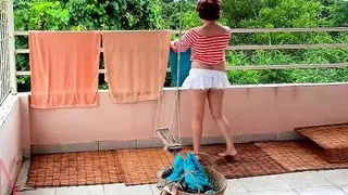 Naked laundry. The maid is drying clothes in the laundry.