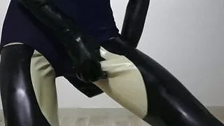 Latex dog crossdresser wearing latex catsuit and swimsuit