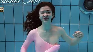 Roxalana Cheh wearing pink dress in the pool