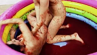 Two hotties in stockings have playful wrestle in small pool