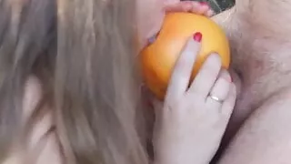 A busty beauty jerks off her boyfriend with a grapefruit