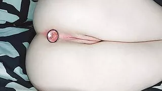 The babe inserts the plug into her tight ass.