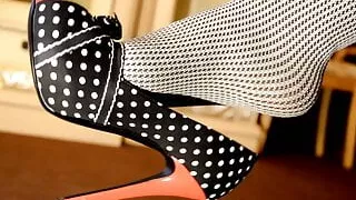 Feet dangling and teasing in grey opaque pantyhose