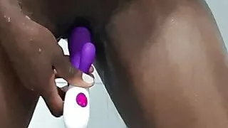 Ebony masturbating in the shower with toy
