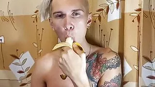 Sweet boy eats a banana greedily