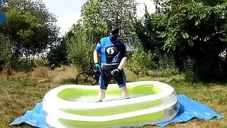 Cyclist pup in pool - cooling down and pawing off