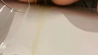 Alex peeing in a glass