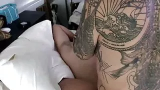 Tattooed tranny masturbates with a cock in her ass