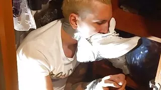 young guy tied sniffing sneaker