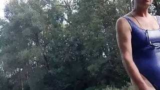 Man in thong swimsuit on a small river