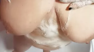 She rubs her huge tits in the shower