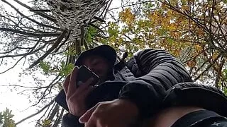 Muscular guy bodybuilder is jerking off in forest outdoor