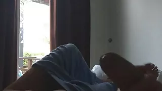 Giving a handjob and showing her naked body in front of window