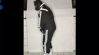 Tracksuit pup pawing off sniffing sneakers