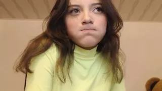 Girl with an innocent face sucks his fingers in a suggestive way