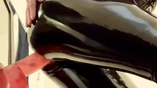 Stacy in latex riding a huge dildo