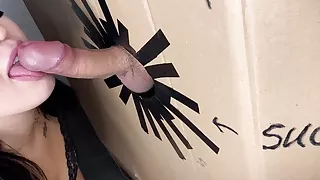 A hole in the wall with a cock and a girl sucking a cock