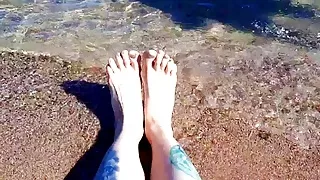 Dominatrix Nika enjoys the salty sea on her feet.