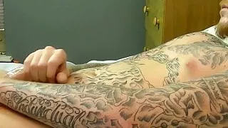 Tattooed amateur jerks off his erect lubed dick and jizzes