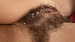 Brunette with small tits gets a cumshot on her hairy pussy