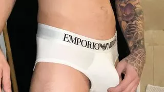 Tattooed stud oiling up monster cock through underwear