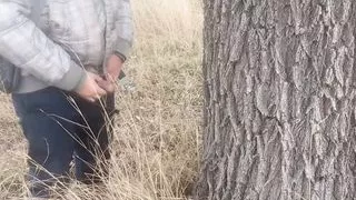 Pissed under a tree. Lots of piss from big cock