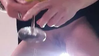 Julie is peeing in a glass