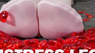 Nylon Foot Play With Red Plastic Hearts On Valentine's Day