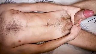 A muscular student jerks off his huge cock and groans sweetly