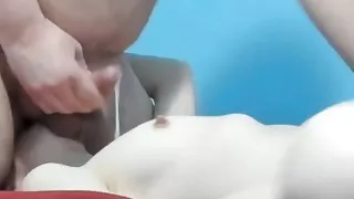 She licks his balls and sprays her tits with hot cum