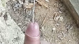 Cumming behind collapsed barn in the woods