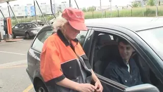 Two buddies share an old blonde woman in the fields