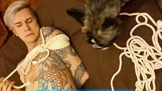 A little puppy is trying to save his cute owner from a difficult rope situation.