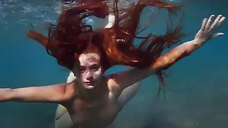 Enjoying a redhead underwater lesbian sex