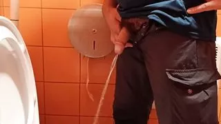 Pissing in an orange public toilet