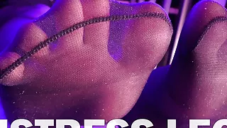 Mistress’s pretty feet in black pantyhose and colored toenails