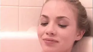 Little April rubbing and fingering pussy in the bathtub