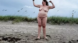 Mature BBW being silly and walking on nude beach.