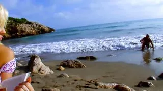 Blond woman fucks an unknown man on the beach