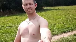 Alex Ray walks naked in a field in nature and poses for the camera