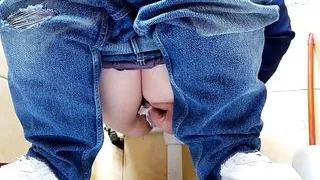 Hot MILF in jeans pissing in a public restroom