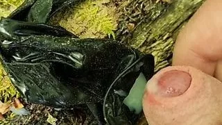 Outdoor cumshot in a used condom in the forest