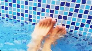 Feet in the pool with water