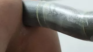 Close-up anal toying with dildo