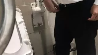 Peeking and spying on a cute office guy peeing in the washroom, watching his dick grow hard and big after peeing