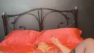 Bella slowly blowing smoke out as she plays with her pussy